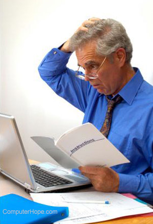 Person looking at a laptop and scratching their head.