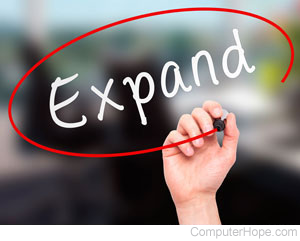 Hand circling the word Expand in red marker.