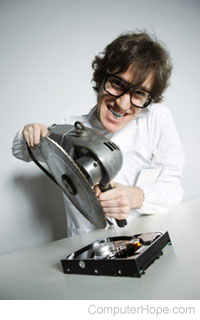 Person using a saw on a hard drive.