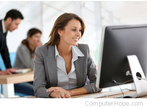 Employee smiling at her desk.