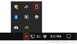 In the Notification Area, click the up arrow to view the systray. Click the Eject media button, which looks like a USB flash drive.